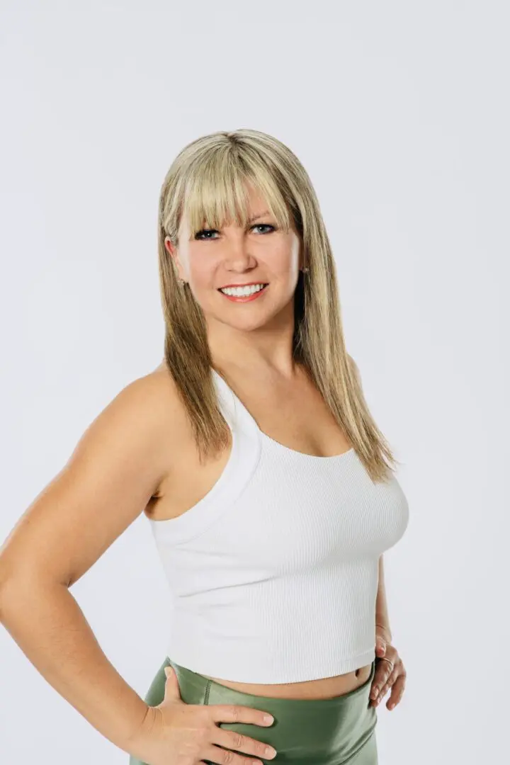 A woman in white shirt smiling for the camera.