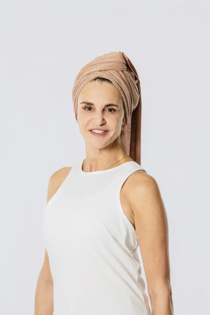 A woman with a towel on her head.