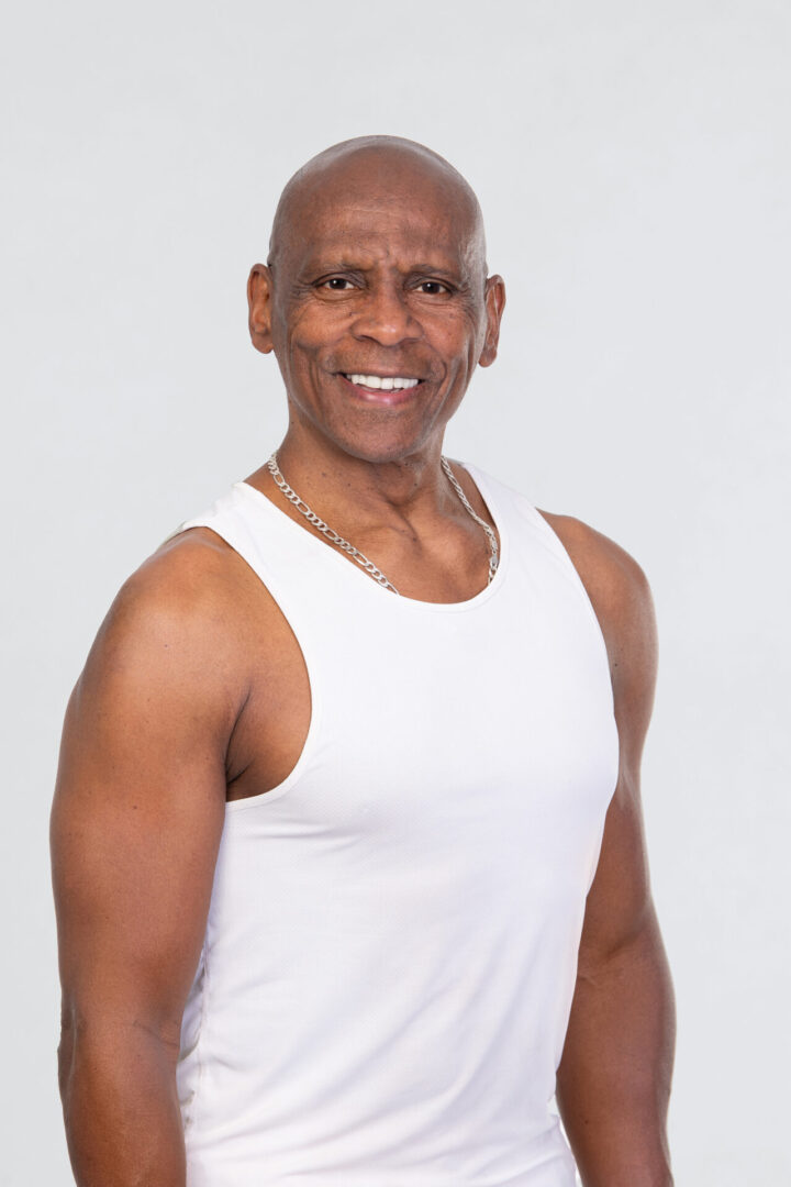 A man in white shirt smiling for the camera.